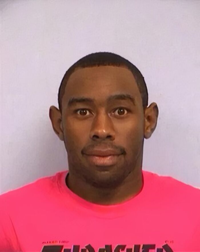 Mugshot of a male celebrity wearing a bright pink shirt, part of a collection of celebs arrested and booked.
