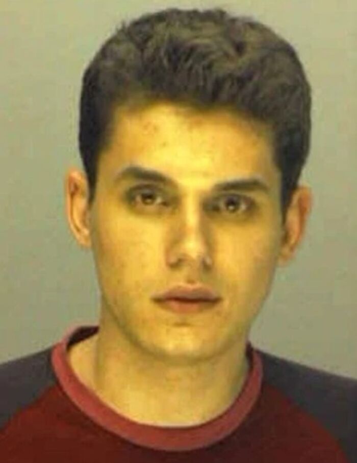 Young male celebrity in a mugshot photo after being arrested, looking directly at the camera with a neutral expression.