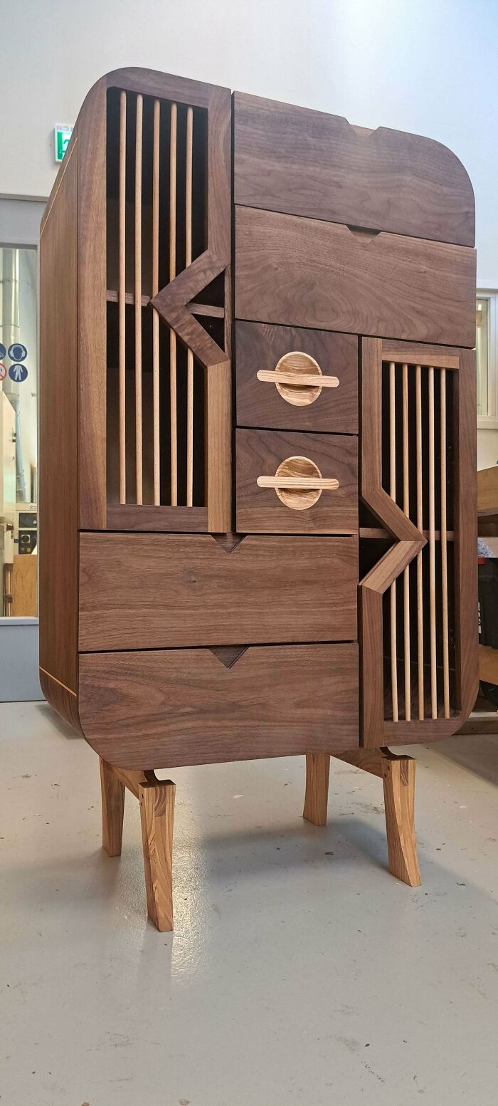 Modern wooden cabinet with intricate carved details and slatted doors showcasing incredible woodworking projects.