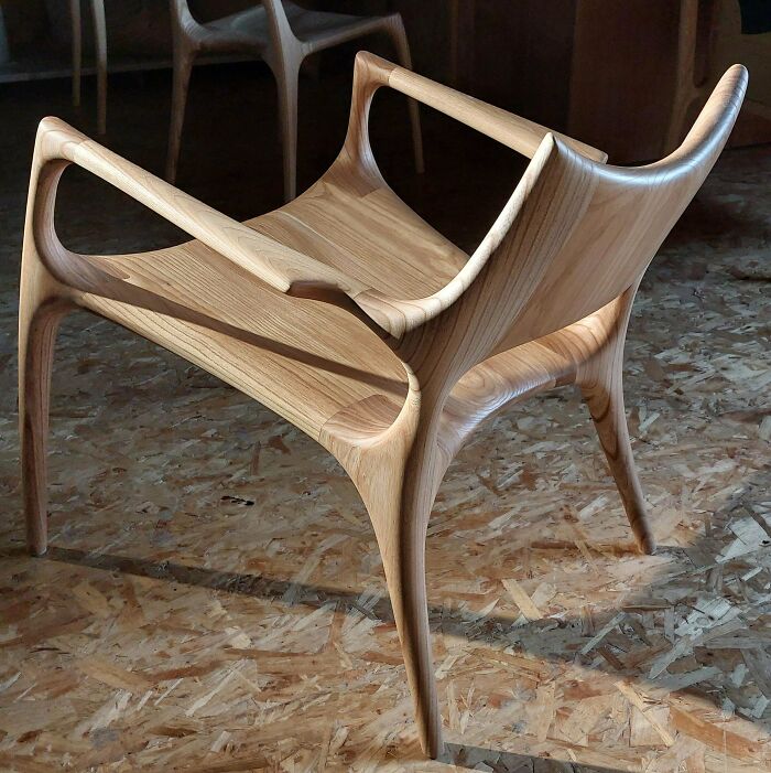 Sleek wooden chair showcasing the craftsmanship and creativity of woodworkers in their incredible projects.