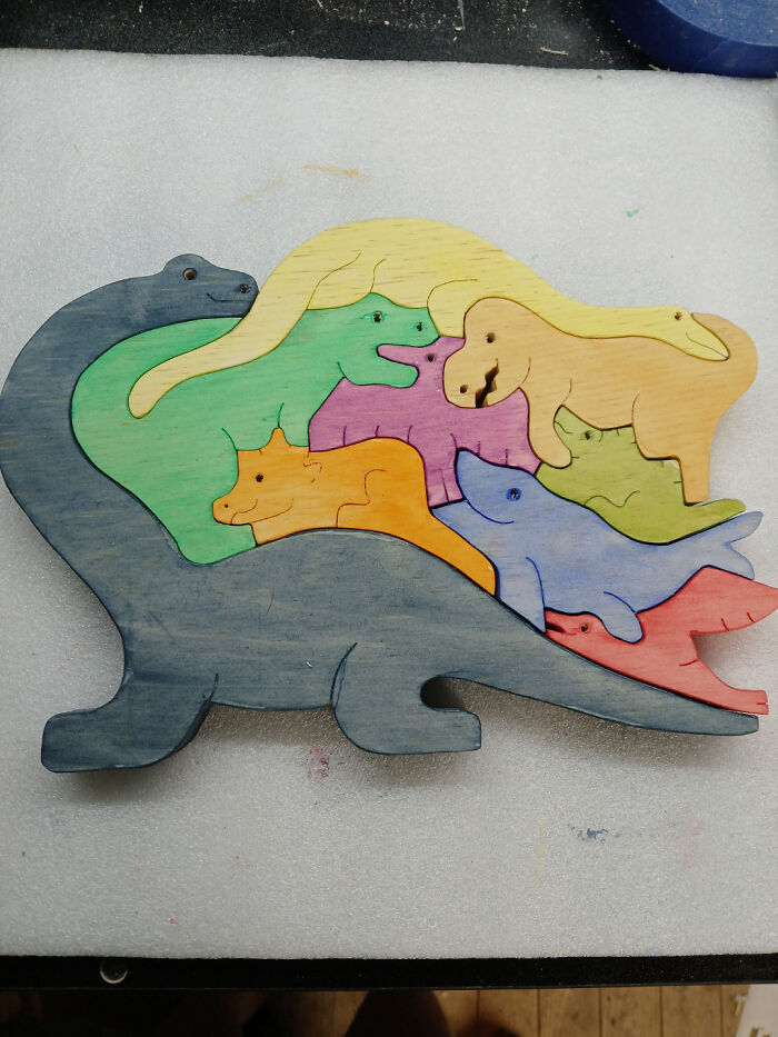 Colorful wooden puzzle featuring various animals carved and painted, showcasing the creativity of woodworkers' projects.