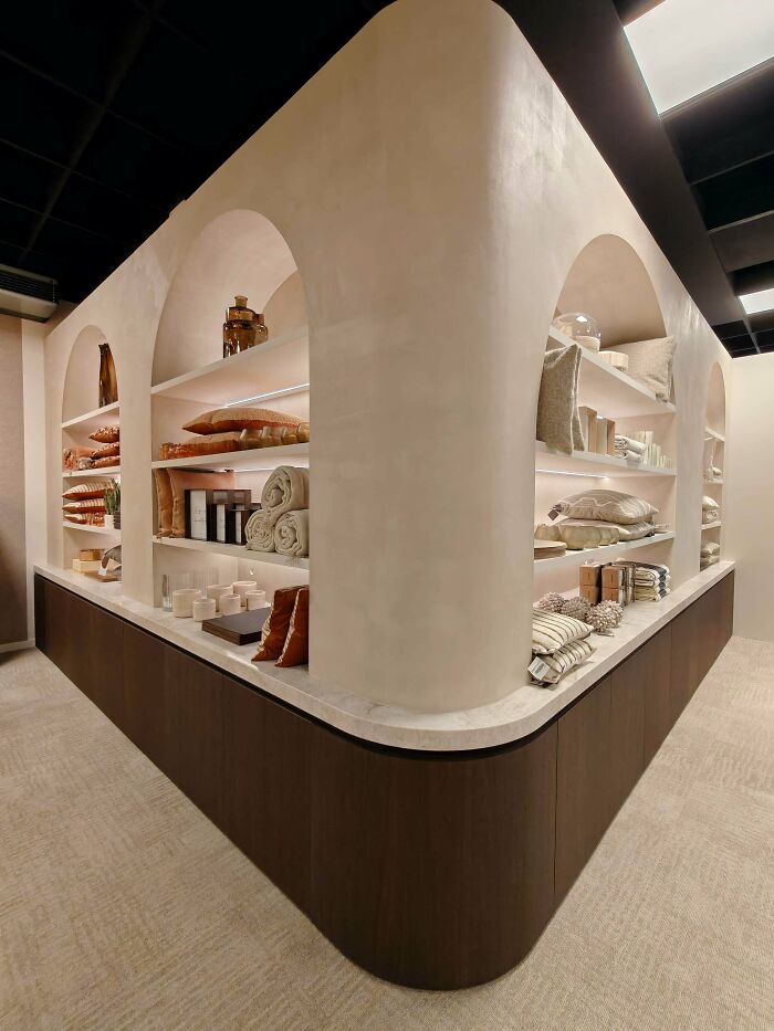 Modern wooden shelves with curved edges displaying home decor items in a stylish woodworking project setting.