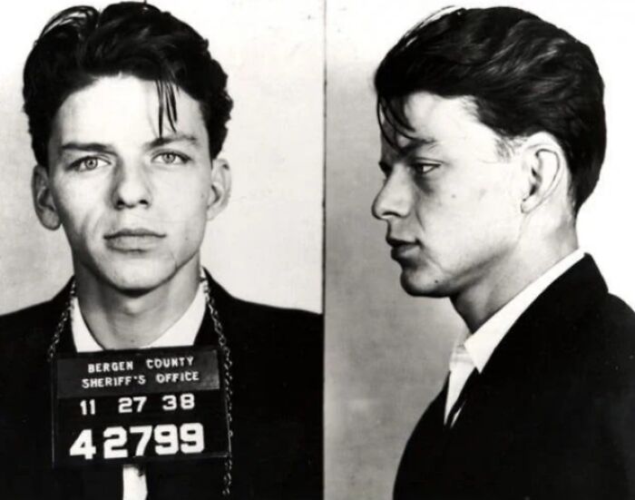 Black and white mugshot photo of a young male celebrity taken after being arrested, showing front and profile views.