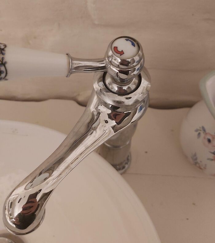 Faucet handle with reversed hot and cold indicators, an example of people doing jobs poorly but impressively.