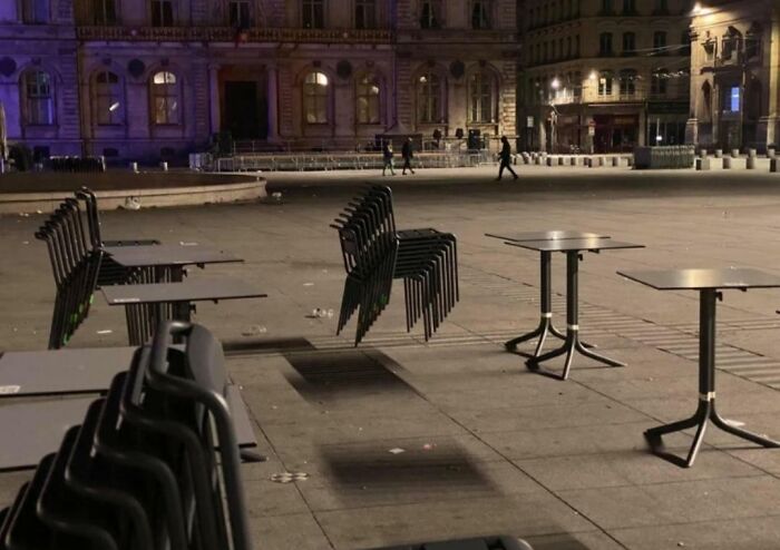 Chairs seemingly floating in mid-air at night, creating a confusing photo that challenges your brain to catch up.