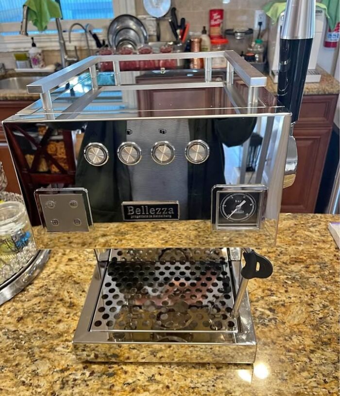 Shiny reflective coffee machine blending into kitchen counter, creating a confusing visual effect.