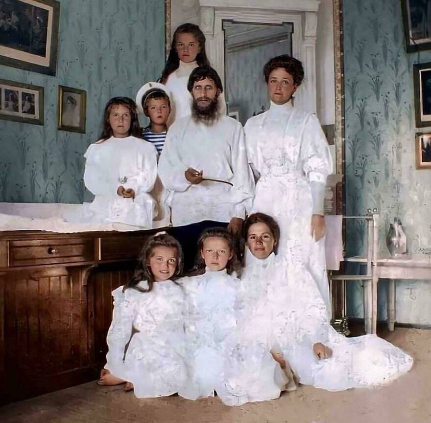 Vintage family portrait with members dressed in white, an intriguing random picture worth going down a rabbit hole for.