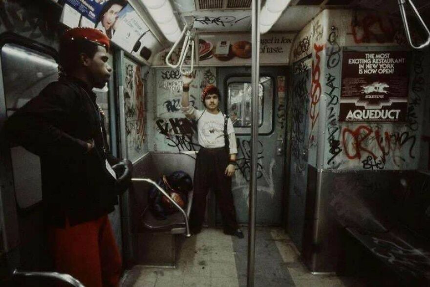 Two men inside a graffiti-covered subway car, showcasing urban life in random pictures worth exploring deeply.