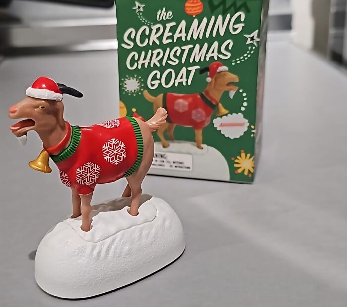 Screaming Christmas goat gag gift wearing a festive sweater and Santa hat, featured as a funny holiday present idea.
