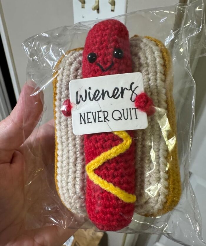 Crocheted hot dog gag gift with a sign, perfect for funny presents and prank gifts for friends who love humor.