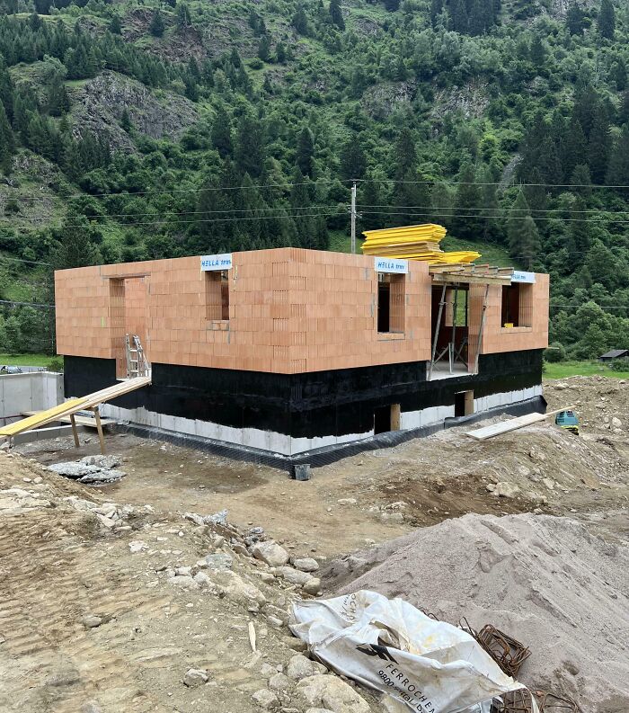 Partially built house foundation in a mountainous area symbolizing people taking a leap of faith in life decisions.