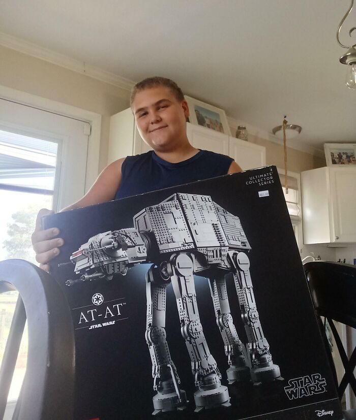 Teen holding a large Star Wars AT-AT Lego set, symbolizing a leap of faith and making bold life decisions.