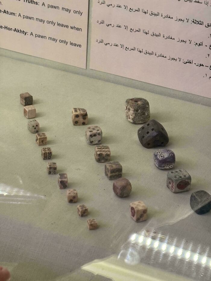 Ancient Egyptian dice displayed in a museum exhibit showcasing incredible artifacts from ancient Egypt.