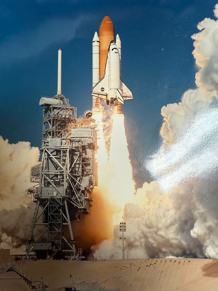 Space shuttle launch captured with bright flames and smoke, showcasing fascinating moments from different jobs in action.