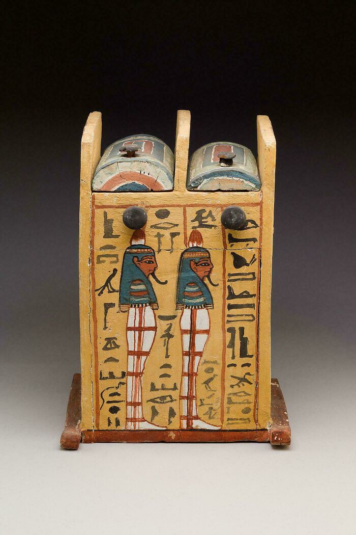 Ancient Egyptian wooden artifact with hieroglyphs and painted figures showcasing art from ancient Egypt.