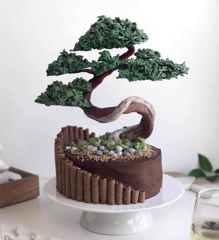 Cake designed as a bonsai tree with textured green foliage and chocolate base showcasing masterfully crafted cake creativity.