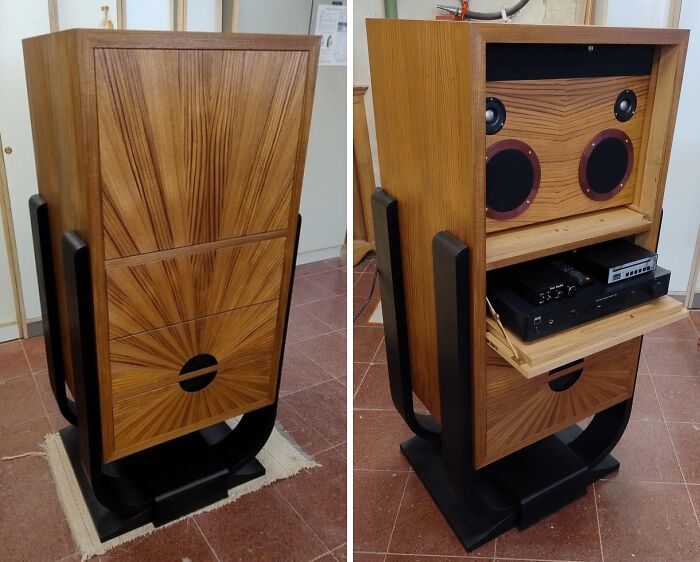Woodworkers crafted a stunning wooden cabinet with intricate sunburst grain design and hidden audio equipment inside.
