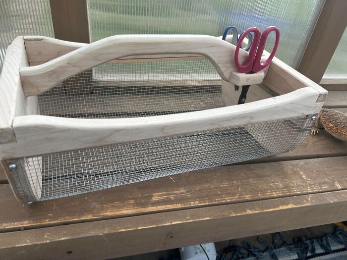 Handcrafted wooden mesh sieve with carved handle, showcasing woodworking skills and creative project design.