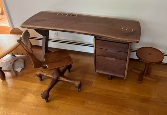 Handcrafted wooden desk and chair set showcasing skilled woodworkers carving intricate and functional furniture pieces.