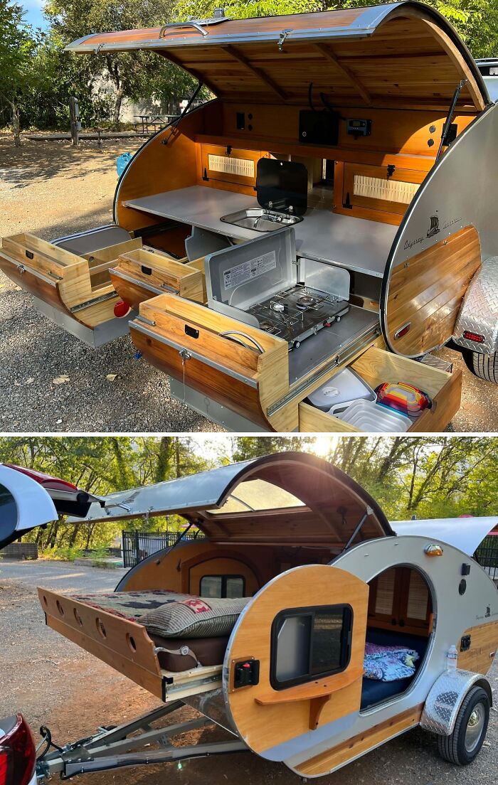 Compact teardrop camper with handcrafted wood cabinetry, storage drawers, and sleeping area showcasing woodworking projects.
