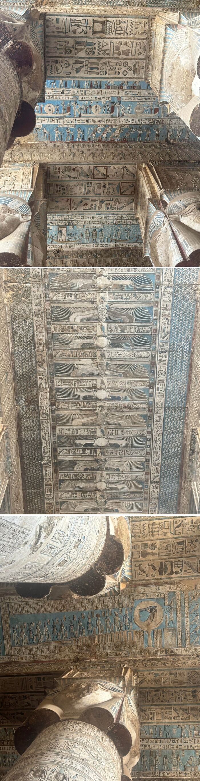 Ancient Egypt ceiling carvings and hieroglyphs with vibrant blue and detailed symbolic artwork inside a historic temple.