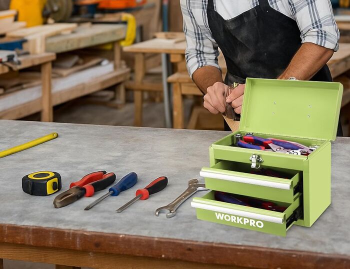 Toolbox and hand tools on workbench with person using hand plane, illustrating gifts found in an isle at Hobby Lobby.