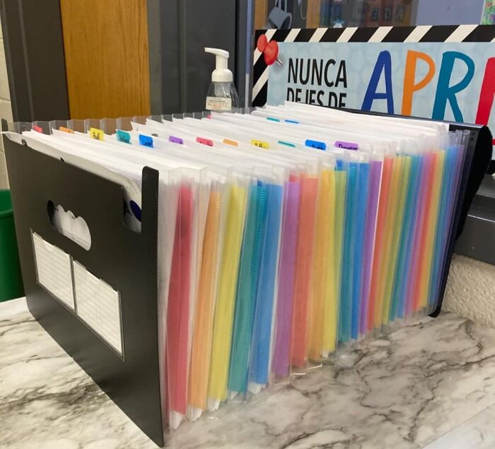 Colorful file folders organized in a black holder, ideal gift for the teacher with patience and caffeine a*******n.