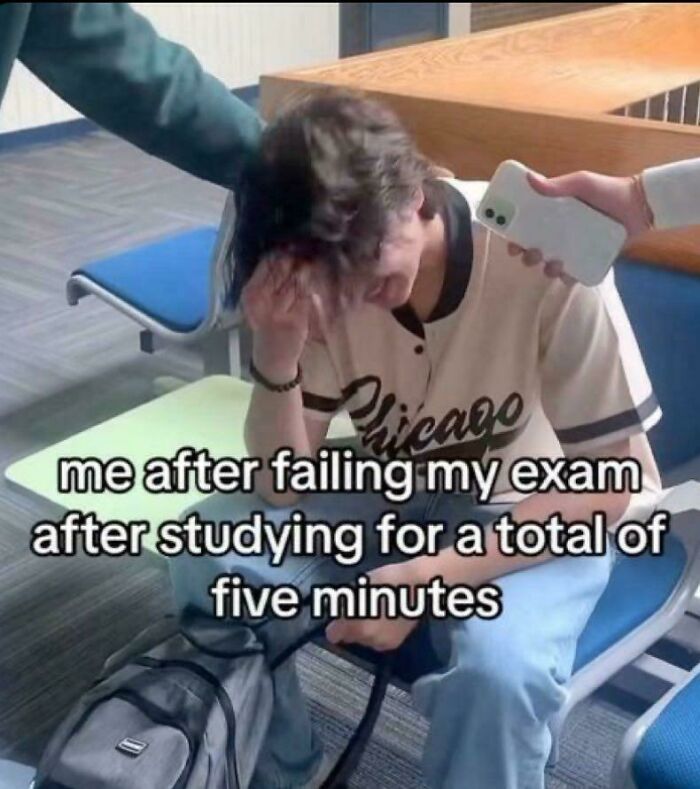 Student looking stressed and holding head after failing exam, reflecting college memes about students running on hope and energy drinks.