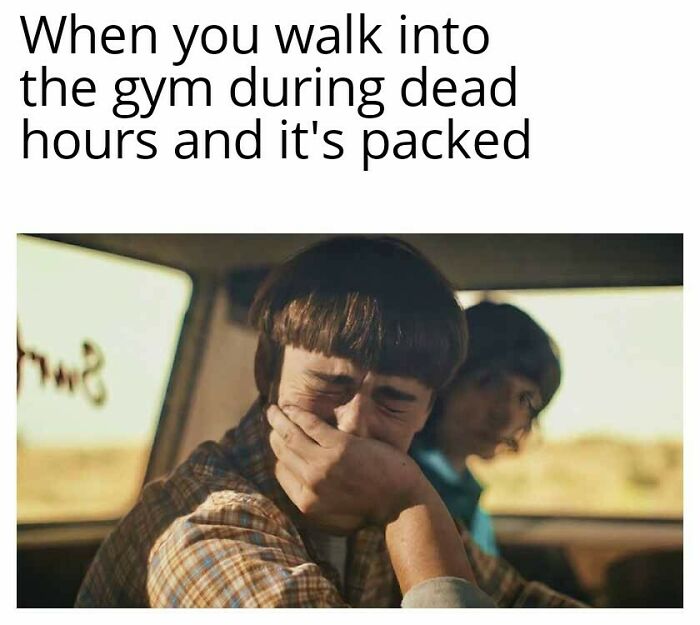 Man covering his mouth in shock inside a car with another person, illustrating a funny gym meme for real lifters.