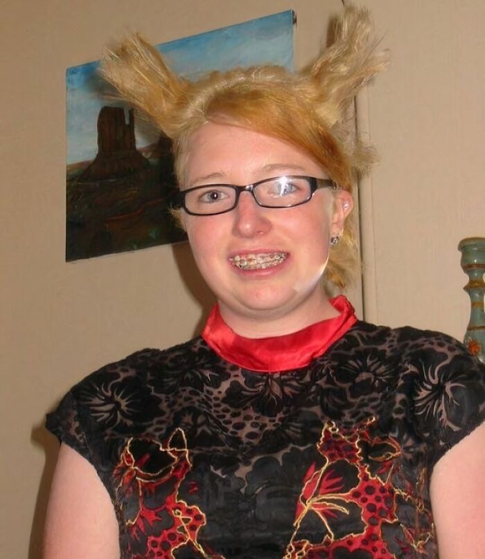 Teen girl with braces and glasses posing with awkward hairstyle in a hilariously awkward childhood photo.