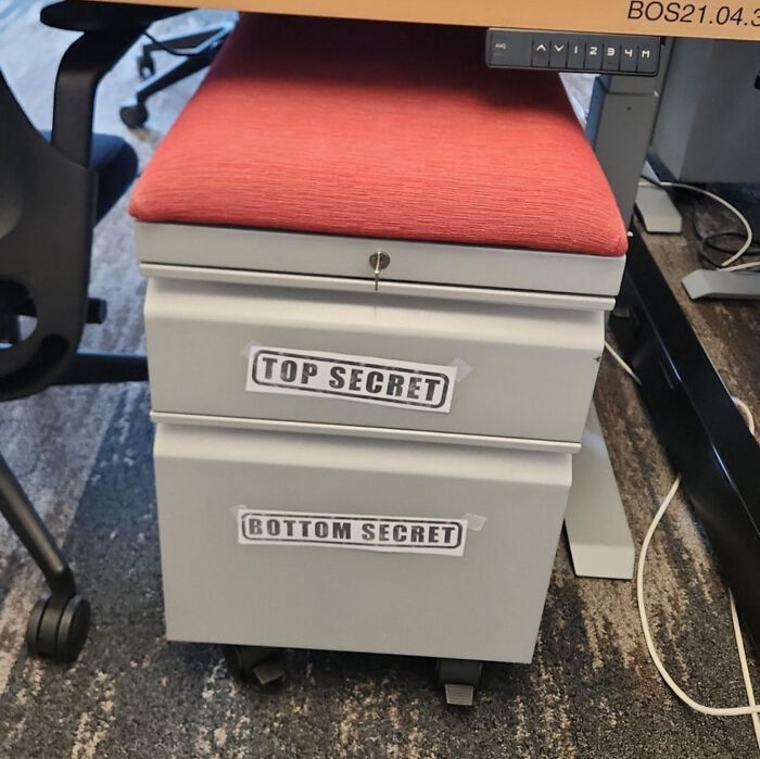 Office drawer with humorous top secret and bottom secret labels, showcasing a hilariously stupid funny post idea.