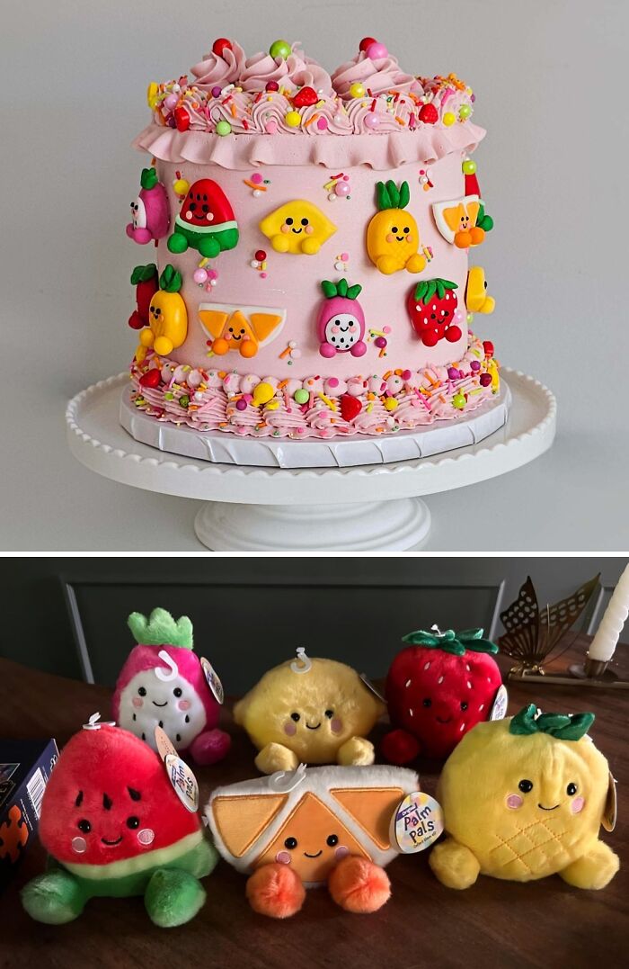 Pink cake with colorful fruit decorations and matching plush toys, showcasing masterfully crafted cake creativity and design.