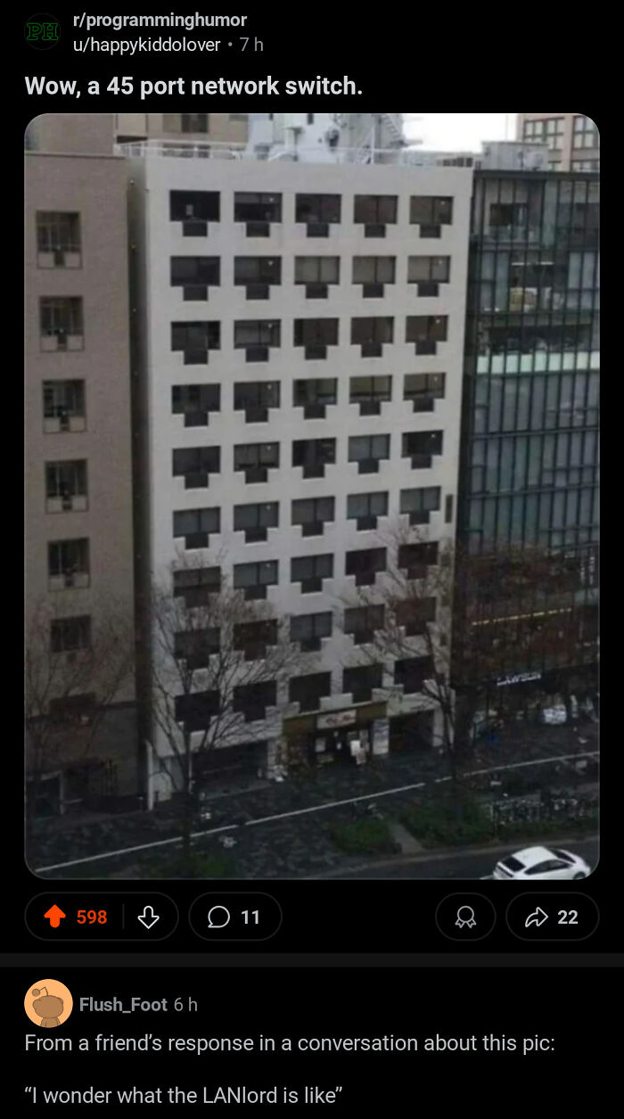 Building facade with windows shaped like a 45 port network switch, shared on programming humor for stupid posts.