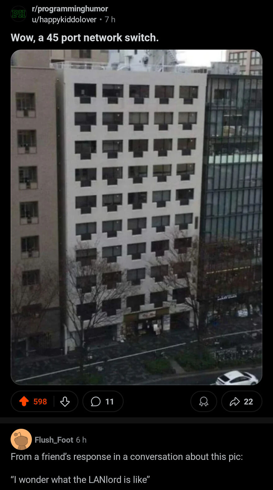 Apartment building with windows shaped like network ports, humorously referred to in a joke rewarded with angry upvotes.