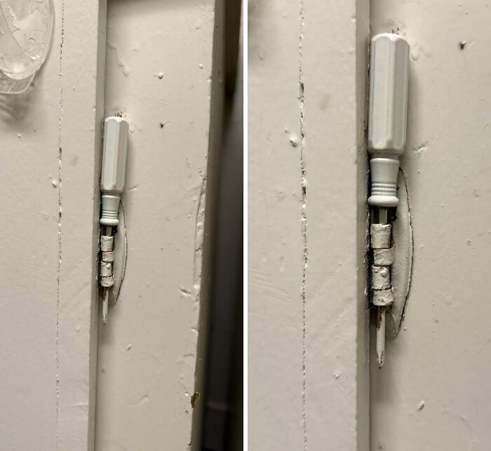 Close-up of a door hinge with makeshift repair showing rental nightmares where landlords tried to cut corners and got exposed.