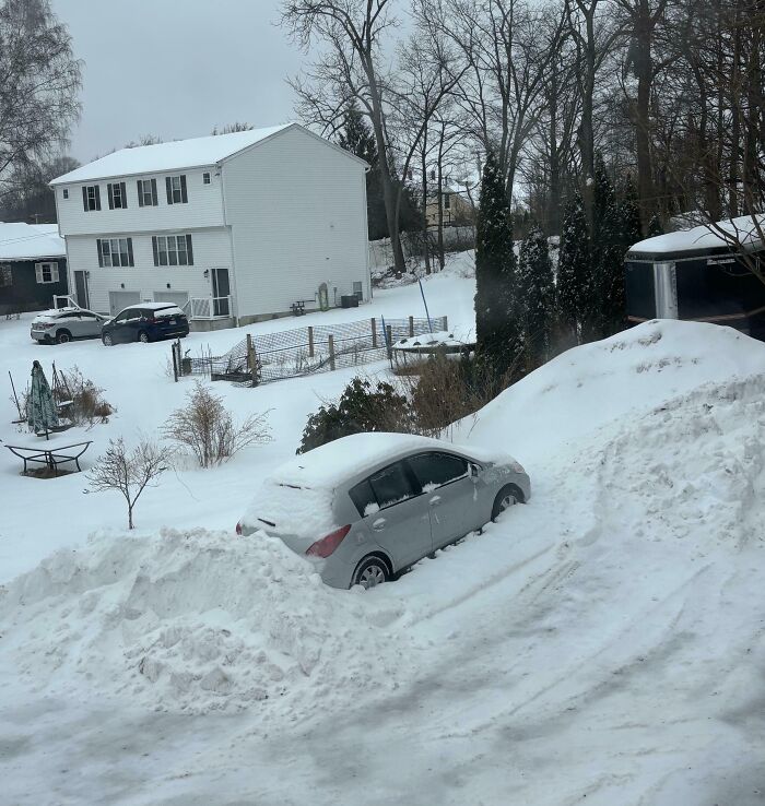 Silver car buried in snow near rental property, showing a rental nightmare where landlords cut corners and exposed issues.