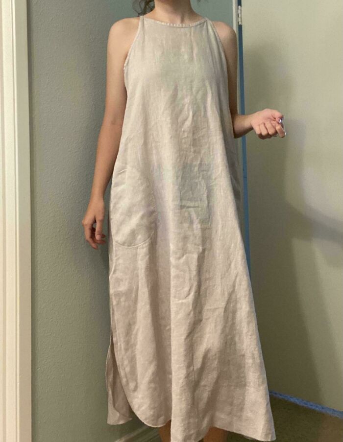 Person wearing a long beige dress found at secondhand stores, showcasing cool and unexpected fashion surprises.
