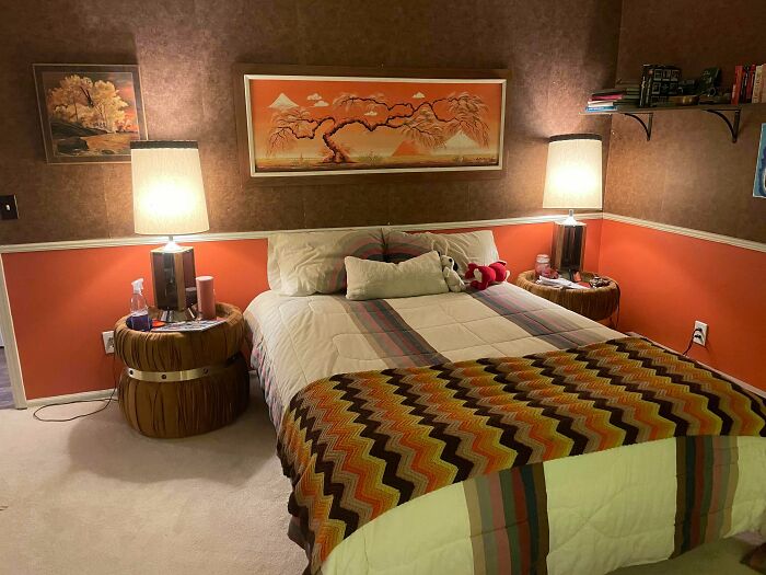 Cozy bedroom featuring vintage decor and secondhand store finds with warm lighting and retro-style furnishings.