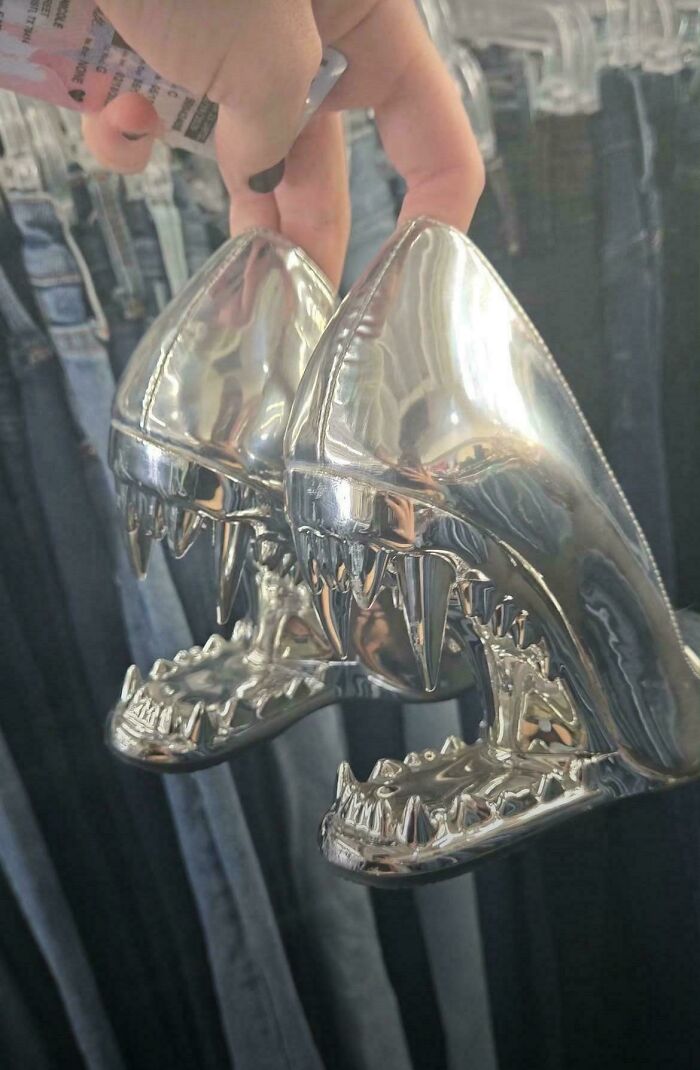 Silver high heels shaped like shark heads with teeth, found as a cool unexpected surprise at a secondhand store.