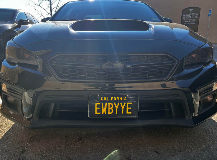 Front view of a black car with a personalized California license plate EWBYYE, showcasing hilarious license plates.
