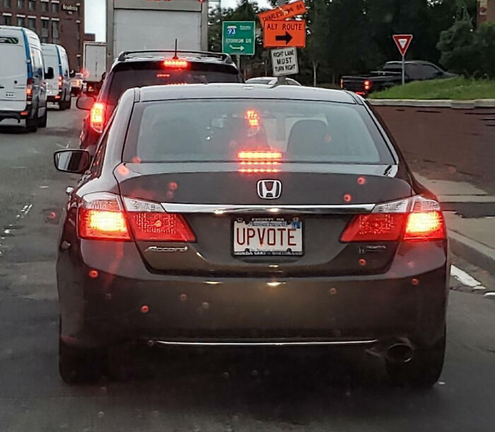 A black Honda Accord with a personalized license plate reading UPVOTE, part of hilarious personalized license plates.