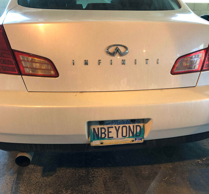 White Infiniti car with a personalized license plate reading NBEYOND, showcasing hilarious personalized license plates.