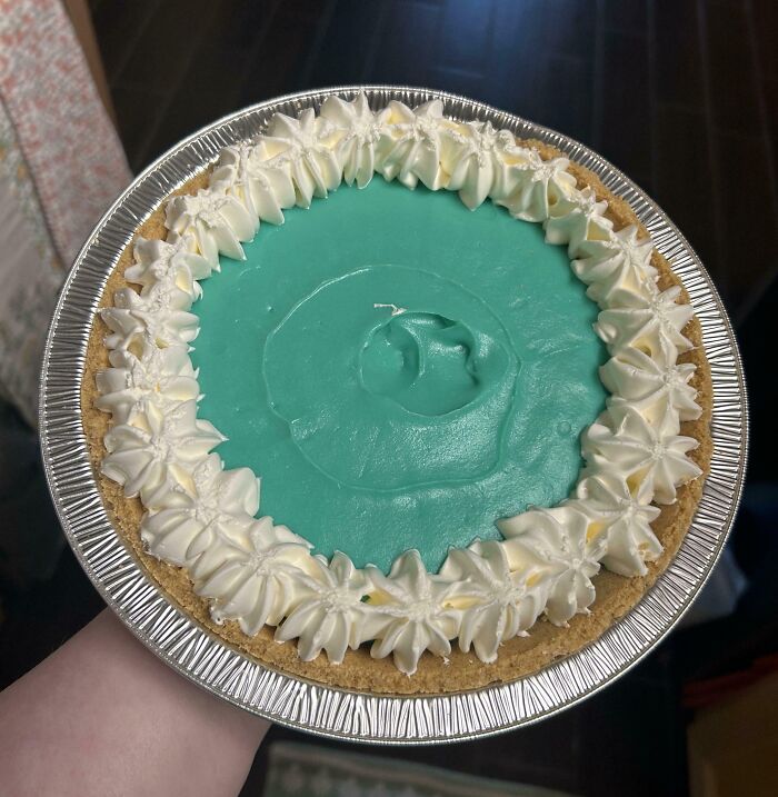 Handheld pie with blue filling and white whipped cream border illustrating outrageous meals that looked nothing like menu photos.
