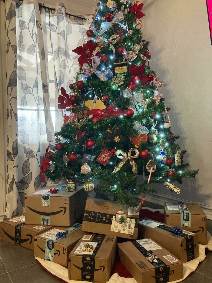 Christmas tree decorated with lights and ornaments surrounded by Amazon boxes, highlighting funny gift wraps inspiration.