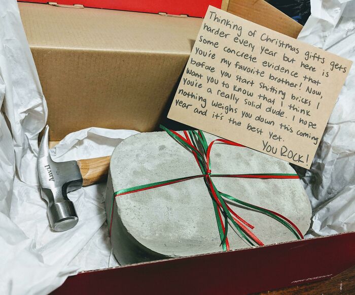 Concrete block wrapped with ribbon and a hammer as a funny gift wrap idea for Christmas mischief and humor.