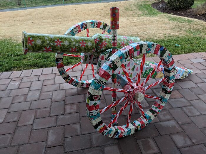 Cannon wrapped in colorful Christmas gift wrap, showcasing creative and funny gift wraps for holiday mischief inspiration.