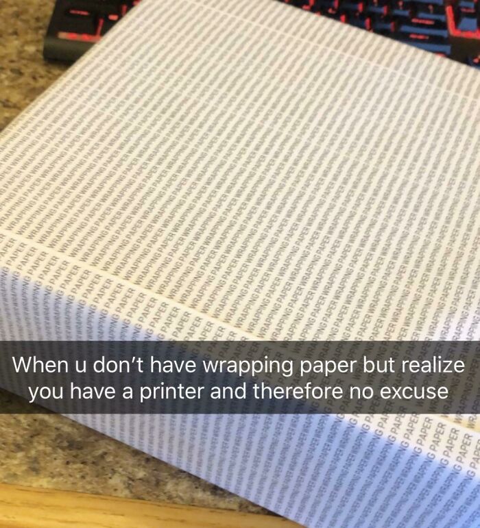 Gift wrapped box covered with printed paper that repeatedly says wrapping paper, a funny gift wrap idea for Christmas.