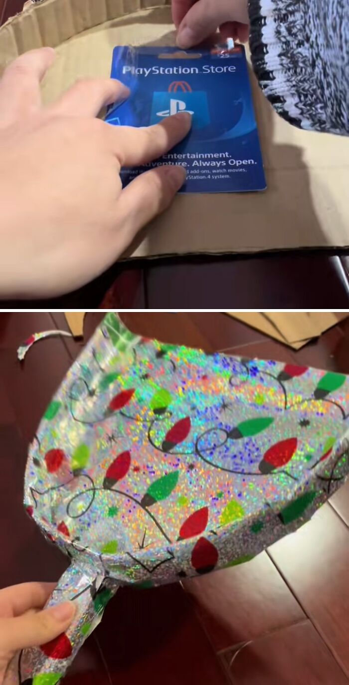 Hands wrapping a PlayStation Store card with shiny Christmas lights gift wrap in a funny gift wrap idea for holiday mischief.