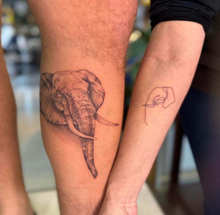 Elephant and minimalist holding hands tattoos on two arms, showcasing wholesome tattoos with deep meaning.