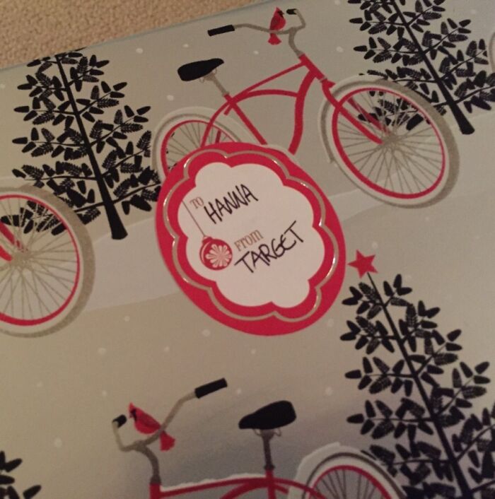 Gift wrap with red bicycles and black trees, featuring a festive tag labeled from Target for Christmas gift wrapping inspiration.